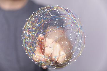 Hand interacting with a digital sphere, representing global network and connection.