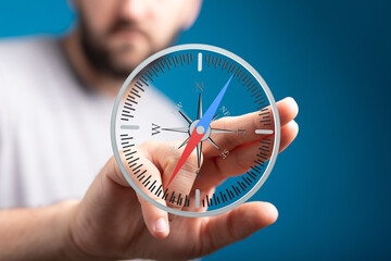 Image of a person interacting with a digital compass, symbolizing guidance and strategic planning.