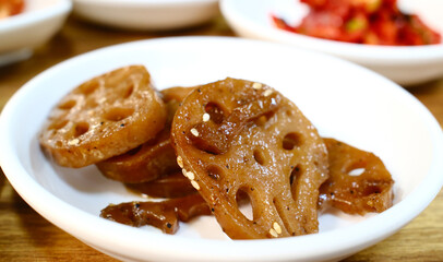 Glazed lotus root slices in sweet soy sauce Korean banchan side dish with traditional holes pattern and caramelized finish