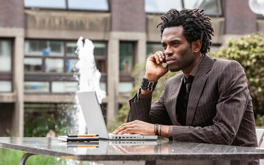 Working Outdoors. A young business professional working out of the office. From a series of images...
