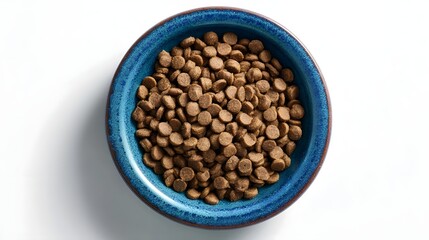 Fototapeta premium A top down view of a blue ceramic bowl filled with brown crunchy dog kibble pieces placed on a clean white background
