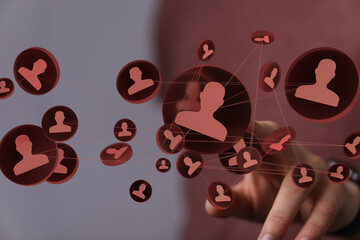 Image of a hand interacting with a network of interconnected profiles, symbolizing global...