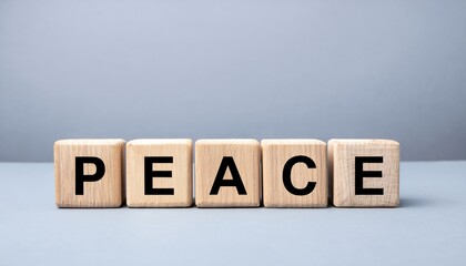 wooden blocks with black bold letters spelling peace on soft gray background, symbolizing harmony and calm, ideal for web design, branding, or mental health poster

