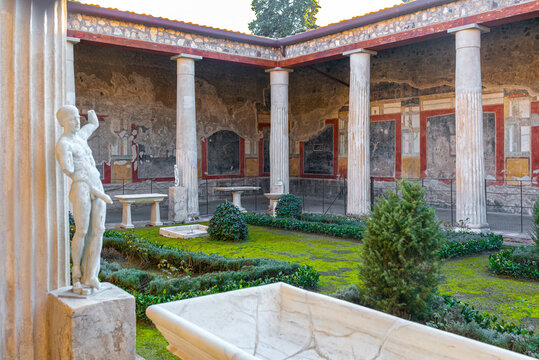 The House of the Vettii, with its garden and peristyle, is located in Pompeii, Italy. The statue depicts Priapus, the god of fertility
