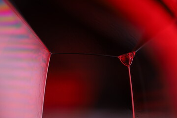 Red reflections of liquid in macro, red liquid surface, bubbles in macro, connection of bubbles in...