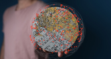 A person holding a digital globe showing interconnected data points. Ideal for technology, global...