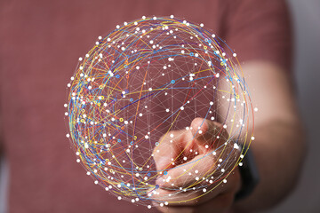 Abstract image of a hand interacting with a digital sphere, representing global network connections...