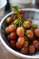 Freshly harvested grapes in a decorative bowl showcasing their vibrant colors and textures