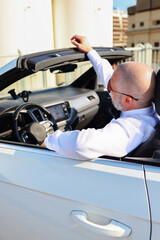 Sophisticated male driver in formal wear, showcasing premium lifestyle and travel