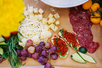 Food on a large served table. a variety of treats and snacks.