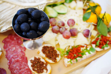 Food on a large served table. a variety of treats and snacks.