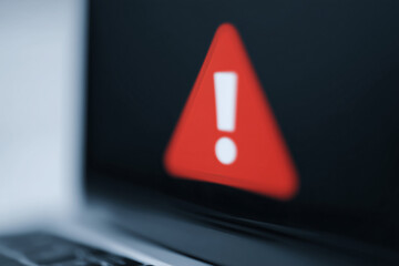 Blurred computer screen showing virus warning popup, digital security alert signaling malware threat, ransomware or phishing attack