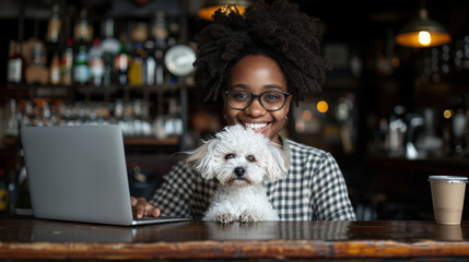 A woman is sitting at a table with a white dog