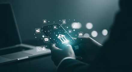 Person using mobile banking app with illuminated digital interface for secure online transactions.