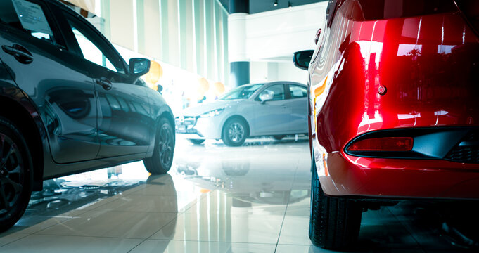 Fototapeta Luxury automobile displayed in modern dealership showroom with sleek interior design where potential customers view premium vehicles for purchasing or leasing high-end cars. Premium car dealership.