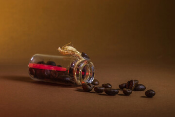 a small bottle with coffee beans on a brown background