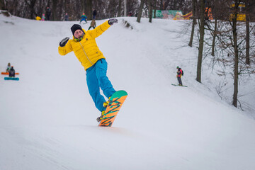 snowboarder rides on mountain slope on snow winter