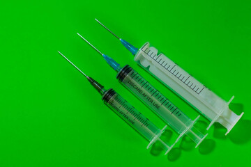 three syringes lie on the green background