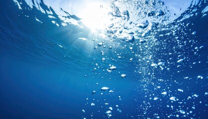 Underwater Bubbles and Sunlight:  Sunlight streams through the ocean surface, illuminating a mesmerizing scene of air bubbles rising through deep blue water. 