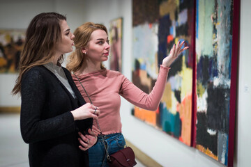 two girls discuss paintings in Gallery of modern art