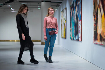 two girls discuss paintings in Gallery of modern art