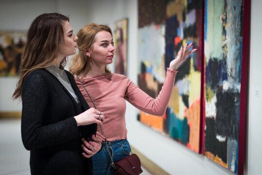 two girls discuss paintings in Gallery of modern art