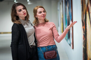 two girls discuss paintings in Gallery of modern art