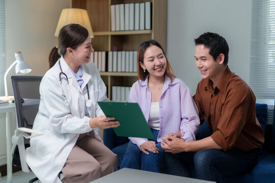 Fototapeta Female doctor discussing diagnosis with a young couple during a medical consultation in a hospital office, providing valuable insights and support