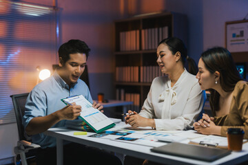 Businessman showing financial reports to colleagues, working late at night in office to meet deadline