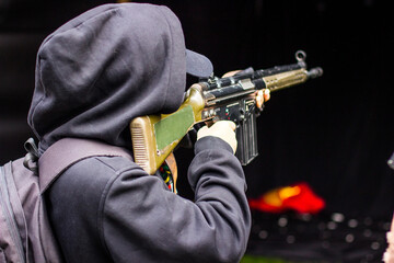 A guy shoots a Kalashnikov.