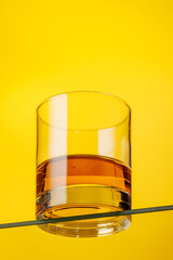 A classic whiskey glass filled with golden amber whiskey