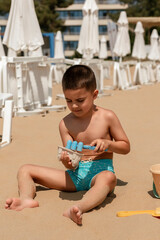 Boy Playing in the Sand on the Beach