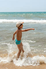 Joyful Kid Playing in Ocean Waves