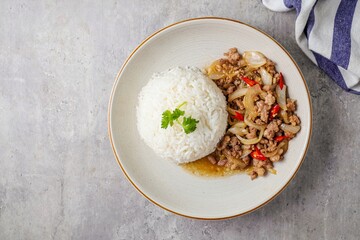 Stir Fried Pork with Onion and Pepper on rice in white plate