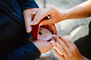 Elegant man proposes to his partner and gives her a ring