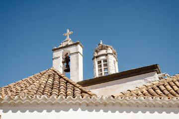 Storks Nesting atop Faro’s Historic Church