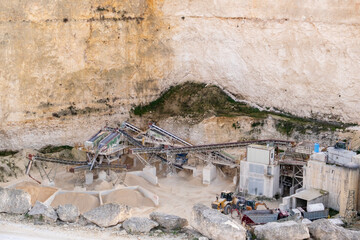 Limestone Quarry with Industrial Machinery in a Cliffside Setting in Malta