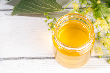 Linden jam, transparent golden floral jam, organic unusual herbal preserve sweets in small jar,...