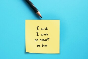 Pencil and note written - I wish I were as smart as her - feel inadequacy when compared to another...