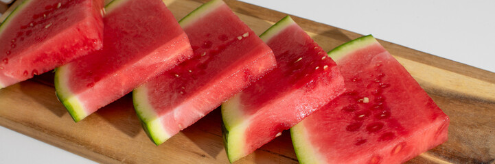Juicy watermelon slices on rustic board, ideal for summer solstice feasting, evokes garden picnics...