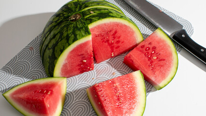 Juicy watermelon slices radiate summer's vibrant zest, echoing Midsummer feasts and carefree...