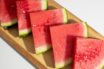Juicy watermelon slices on rustic wood, bursting fresh summer solace, enticing Midsummer Feast,...