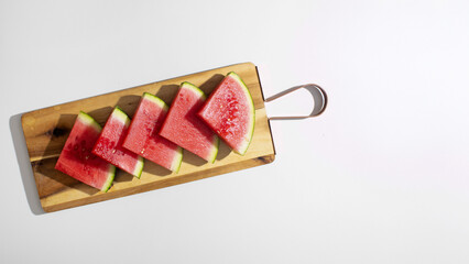 Sliced watermelon gleams on rustic board, evoking summer picnics, Watermelon Day zest, and juicy...