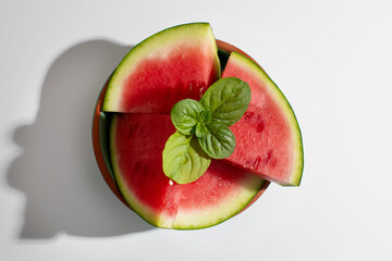 Juicy watermelon slices adorned with fresh mint leaves, summer solstice refreshment, juicy...