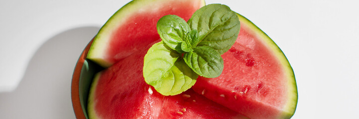 Slices of vibrant watermelon crowned with mint evoke summer solstice feasts, rejuvenating freshness...