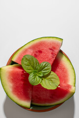 Juicy watermelon slices crowned with mint celebrate midsummer, invoking La Tomatina vibes and...