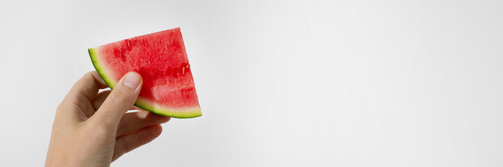 A slice of juicy watermelon held by a Caucasian hand, evoking the whimsical joy of Watermelon Thump...