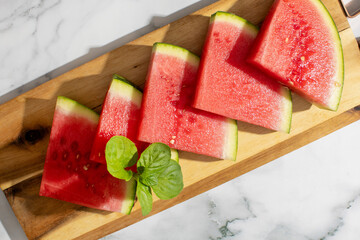 Slices of vibrant watermelon glisten like sweet jeweled fans, perfect for celebrating Obon festival...
