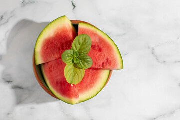 Juicy watermelon wedges garnished with mint bask under sunlight, evoking Midsummer frolics and...