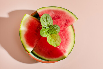Slices of vibrant watermelon adorned with fresh basil, celebrating Midsummers Eve and the whimsical...